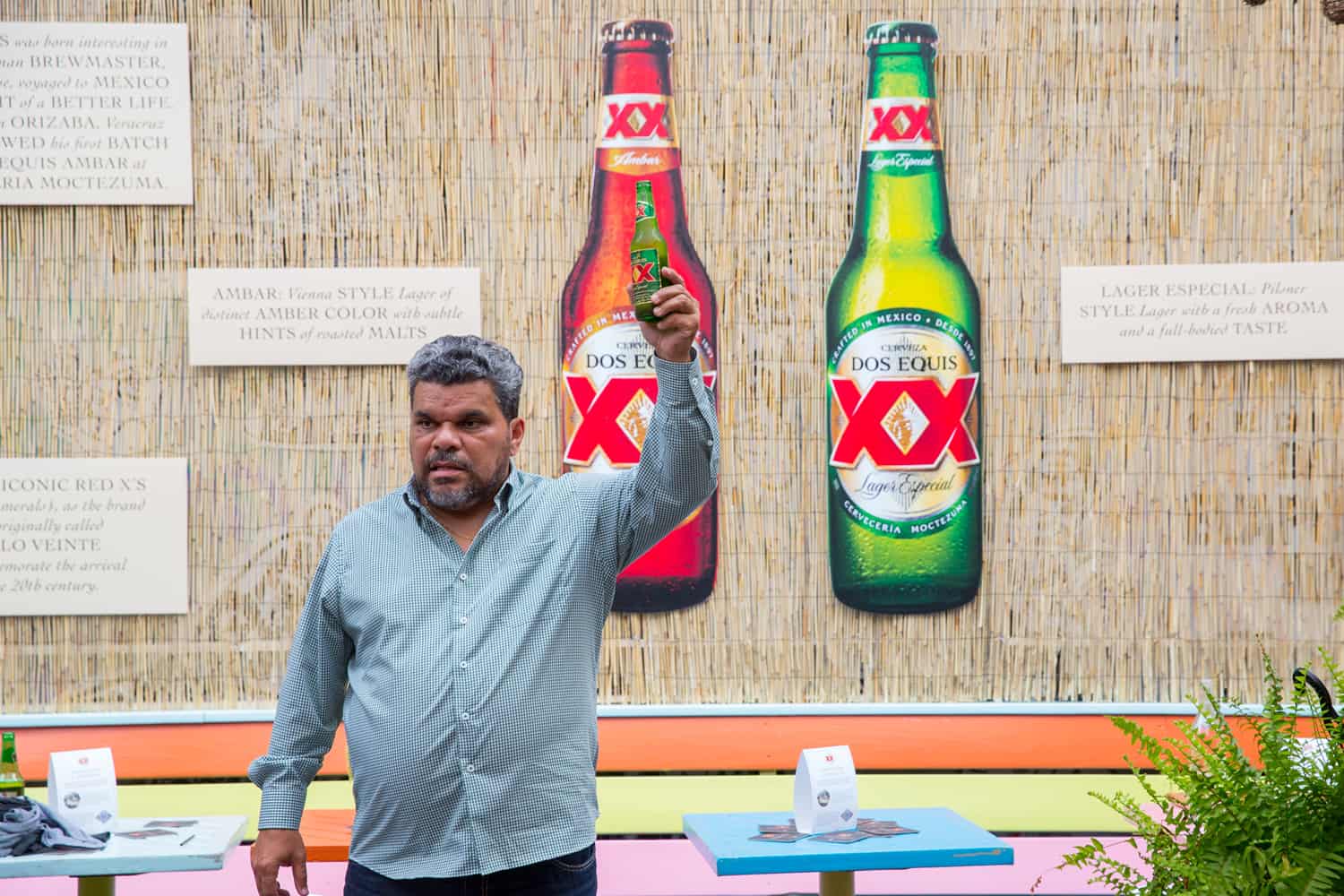 Does Equis spokesman Luis Guzman holding beer in Most Interesting Person Index