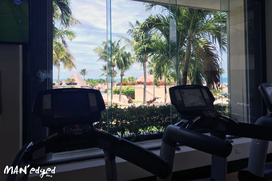 A gym view from treadmills looking out onto beach