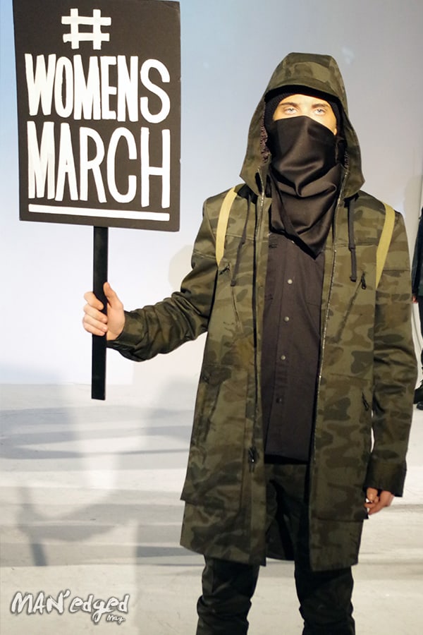Male model holding Womens March sign.