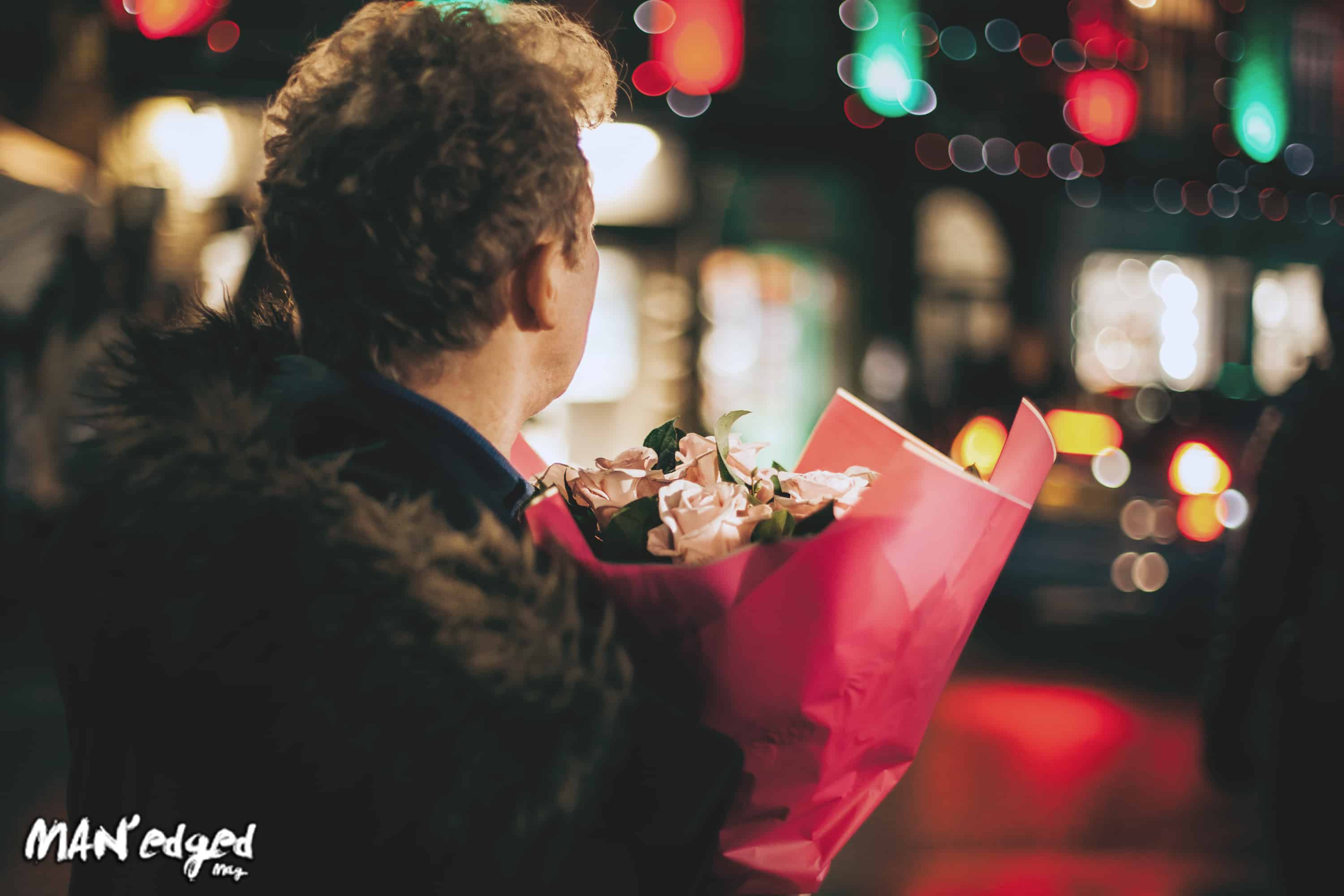 Man holding flowers on first date for MAN'edged Magazine advice column