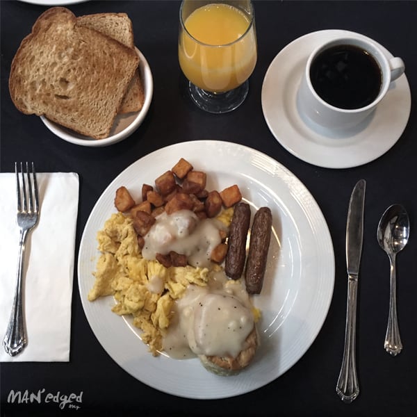 breakfast food plate with eggs, sausage, and coffee.