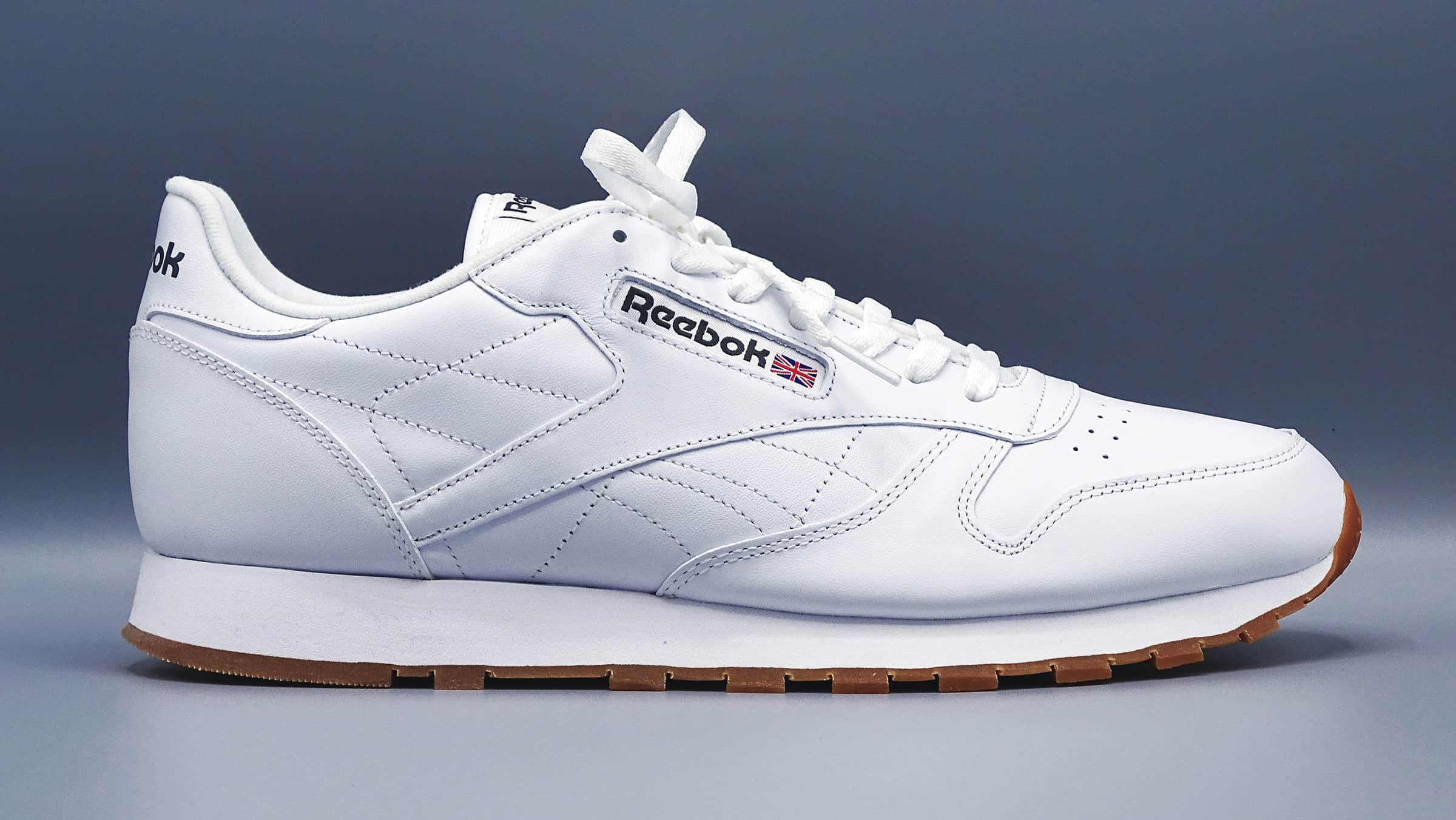 White reebok men's classic sneaker with gum colored bottom