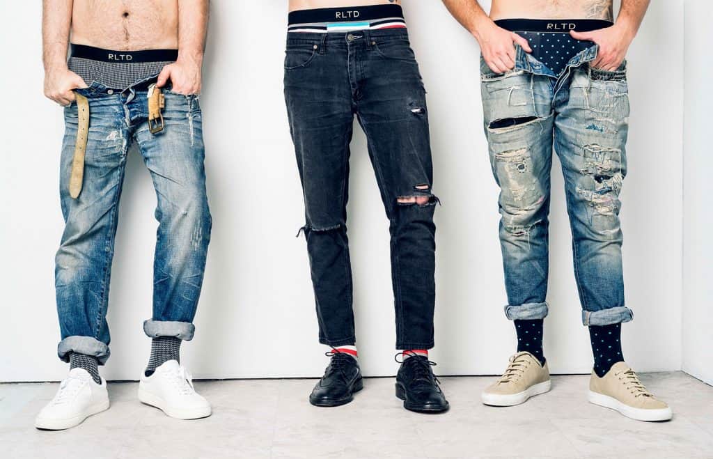 Three guys standing in denim jeans with men's underwear showing featuring Related Garments