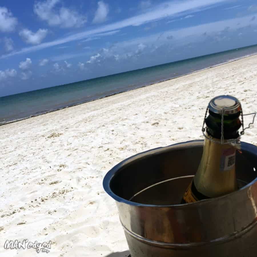 A chilled bottle of champagne on the private beaches of Palace Resorts Moon Palace Cancun.
