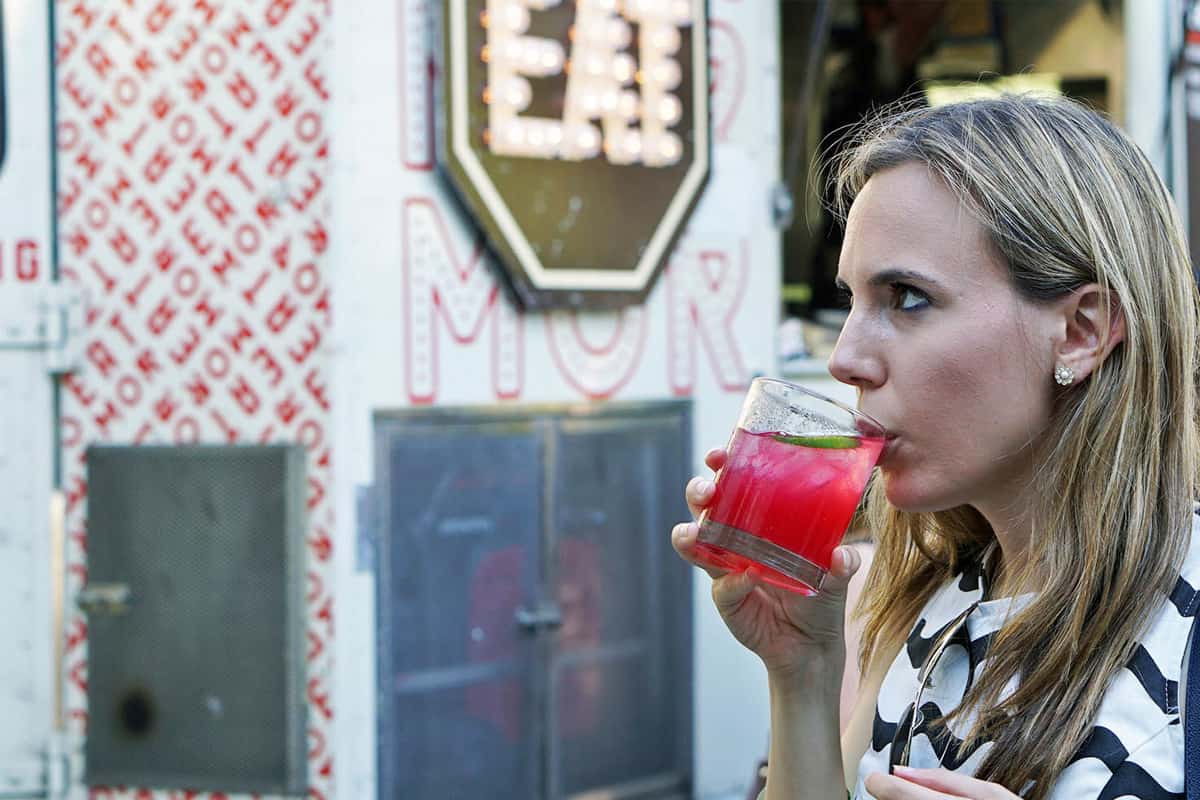 Young woman enjoying cold summer cocktail