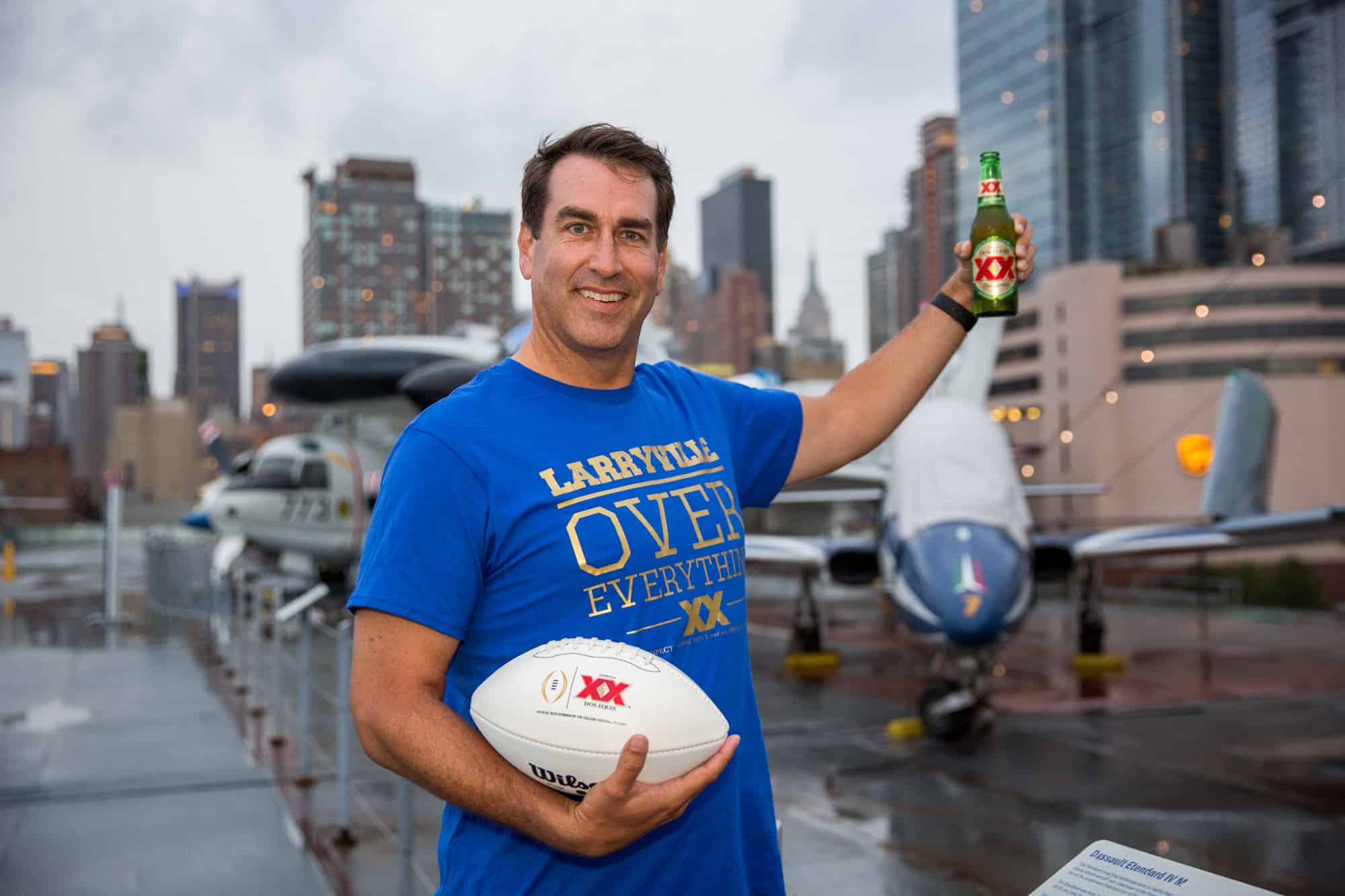 Ron Riggle posing with Dos Equis beer