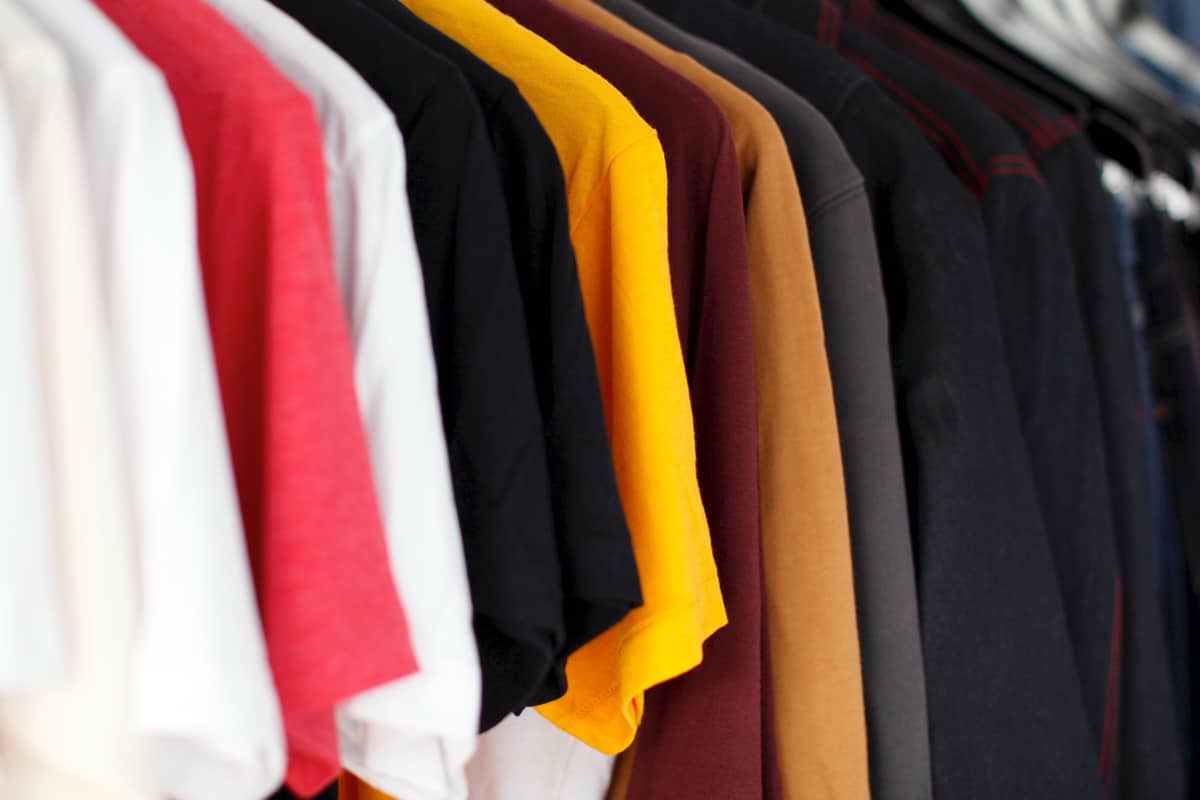 men's clothing hanging inside of a closet