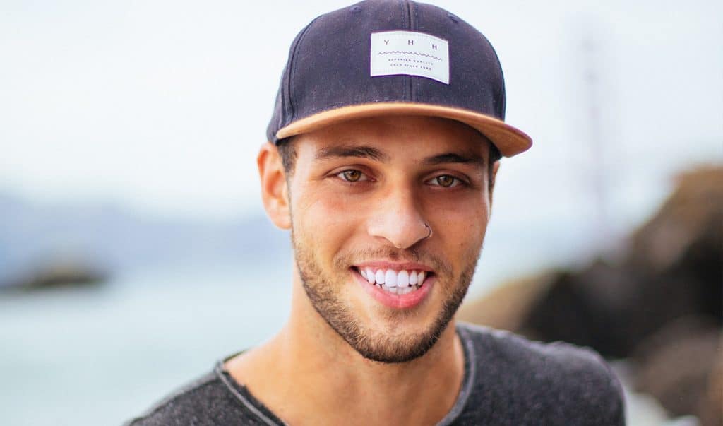 Young guy with cap smiling