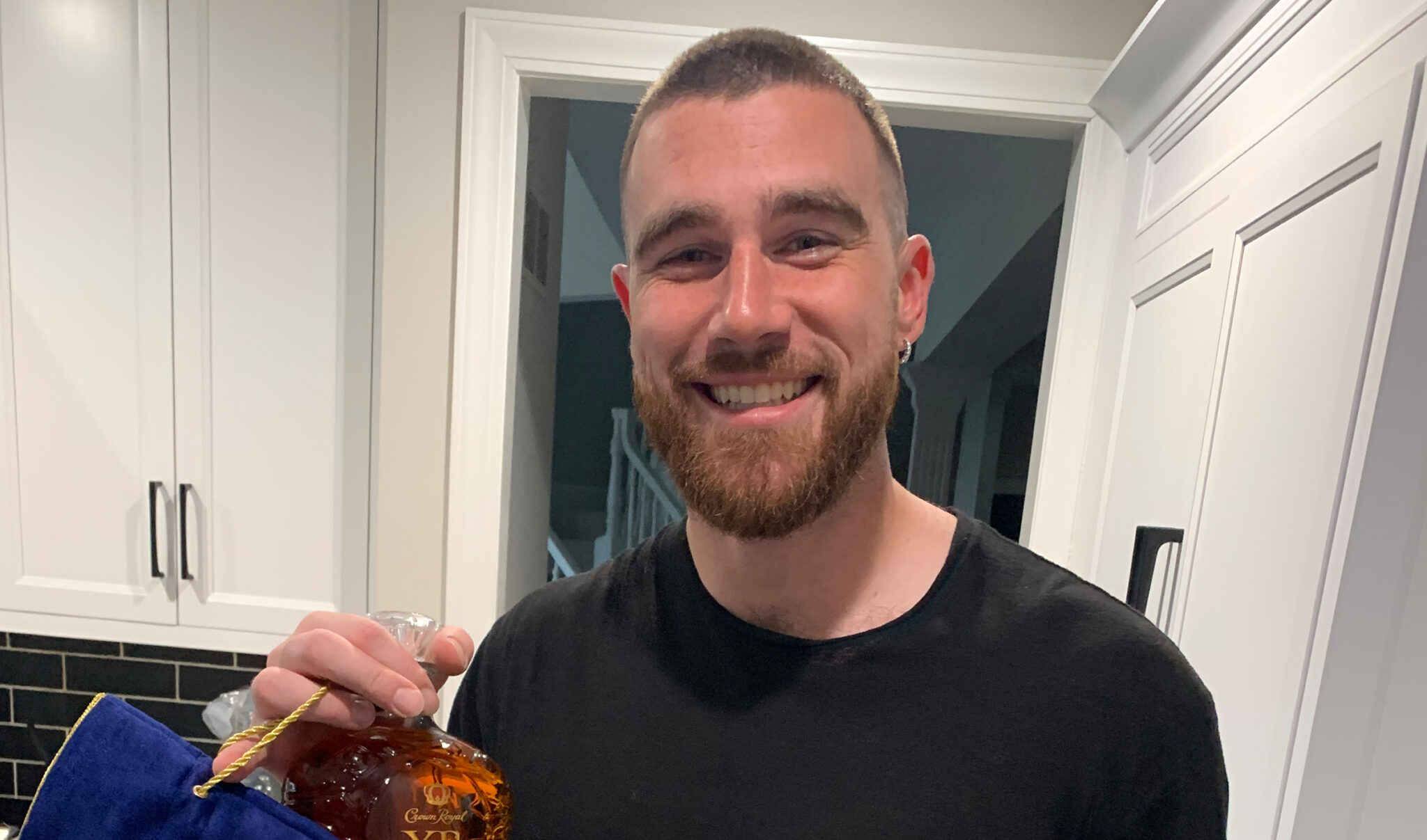 NFL Championship Player, Kelcey Travis of the Kansas City Chiefs holding a bottle of Crown Royal Xr
