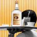 server holding a handle of tito's handmade vodka featured in How much is a handle of Tito's Handmade Vodka Cost article