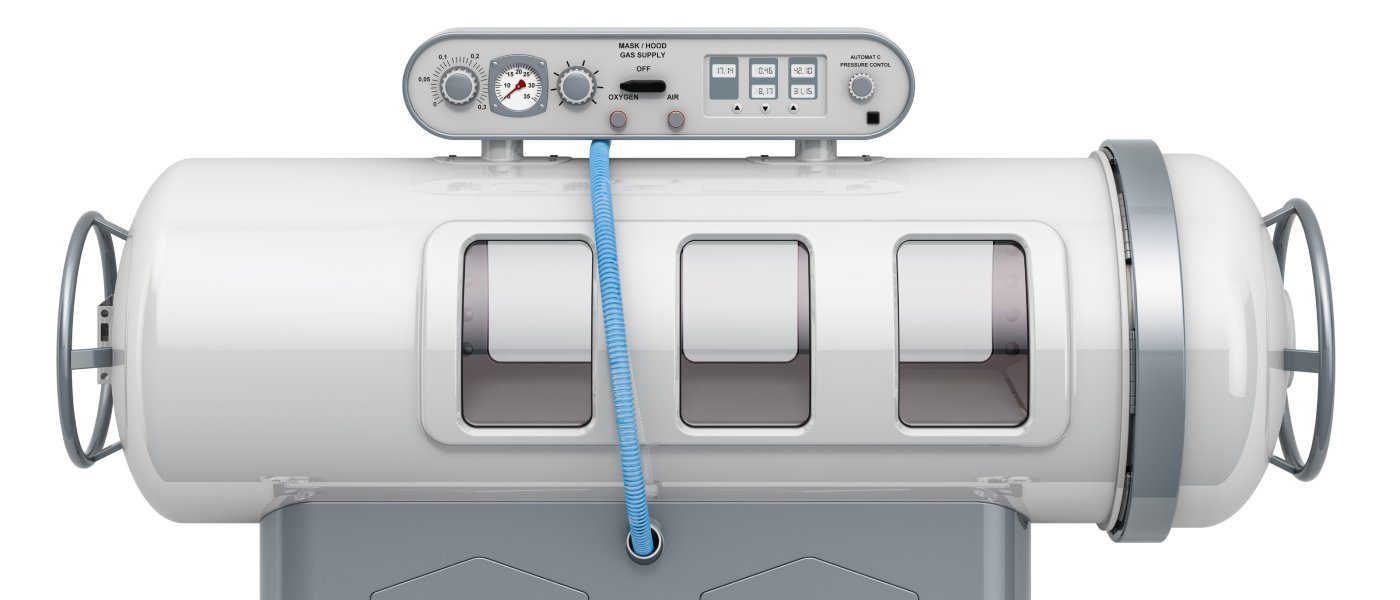 Side view of a hyperbaric oxygen therapy chamber over a white background. The horizontal, tube-shaped chamber is on wheels.