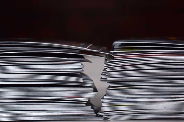 Two stacks of trading cards resting on a light surface with layered edges visible against a dark background.